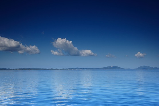 view of an open sea with a cloud on corfu island greece